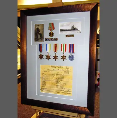 Medals displayed with a service certificate and ribbon bar framed by Tripps of Keynsham