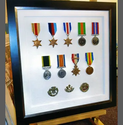 Campaign medals on a white mount framed by Tripps of Keynsham Bristol