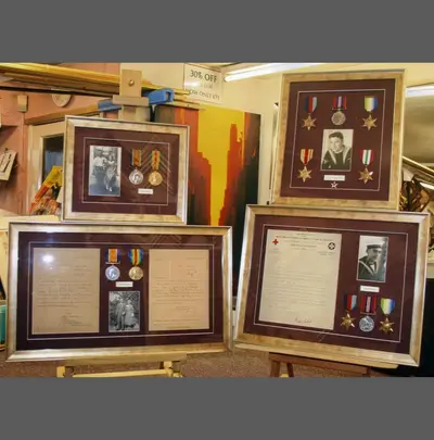 Three framed medal and photograph displays framed by Tripps of Keynsham