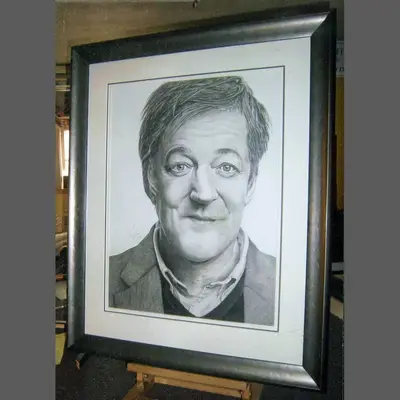 Pencil portrait drawing in a black frame with a white mount framed by Tripps of Keynsham