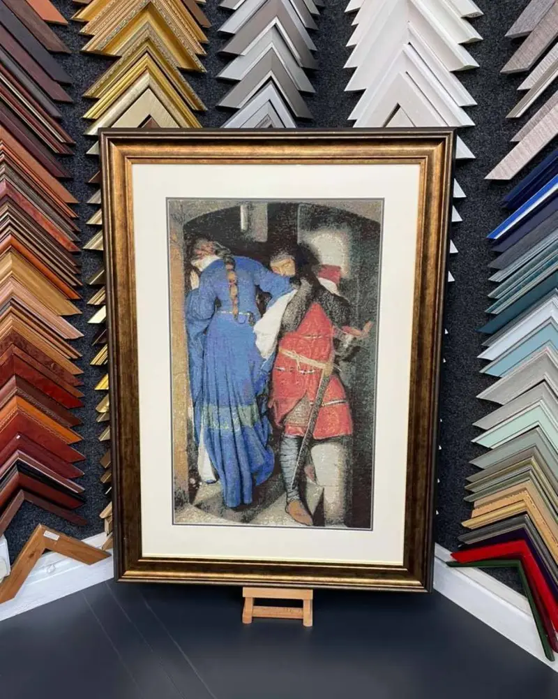 Framed painting shown against corner samples of frame mouldings at Tripps of Keynsham