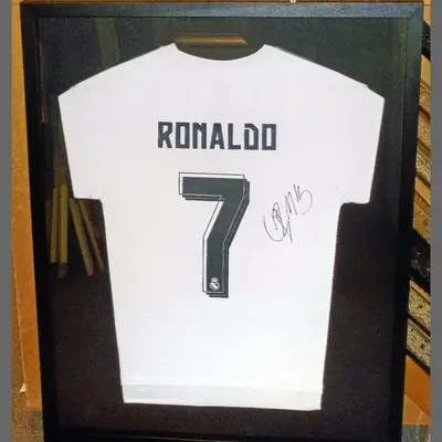 Signed number 7 football shirt in a black box frame framed by Tripps of Keynsham