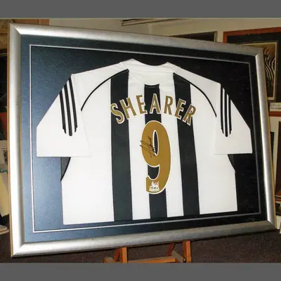 Black and white striped number 9 football shirt in a silver frame framed by Tripps of Keynsham
