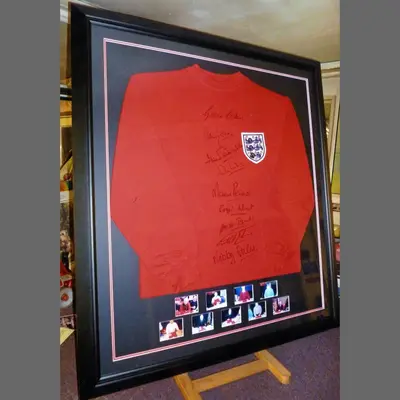 Red England shirt framed with a strip of photographs framed by Tripps of Keynsham