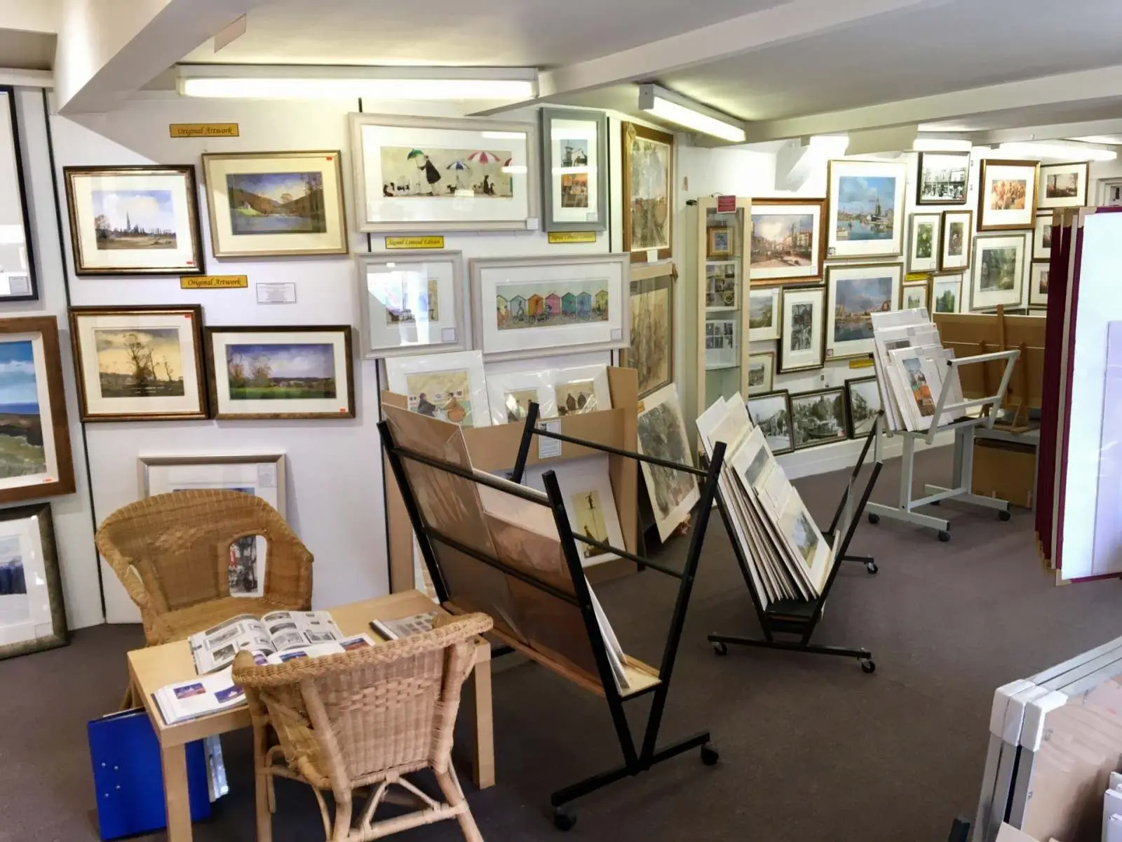 Framed pictures lining the walls inside Tripps of Keynsham on High Street