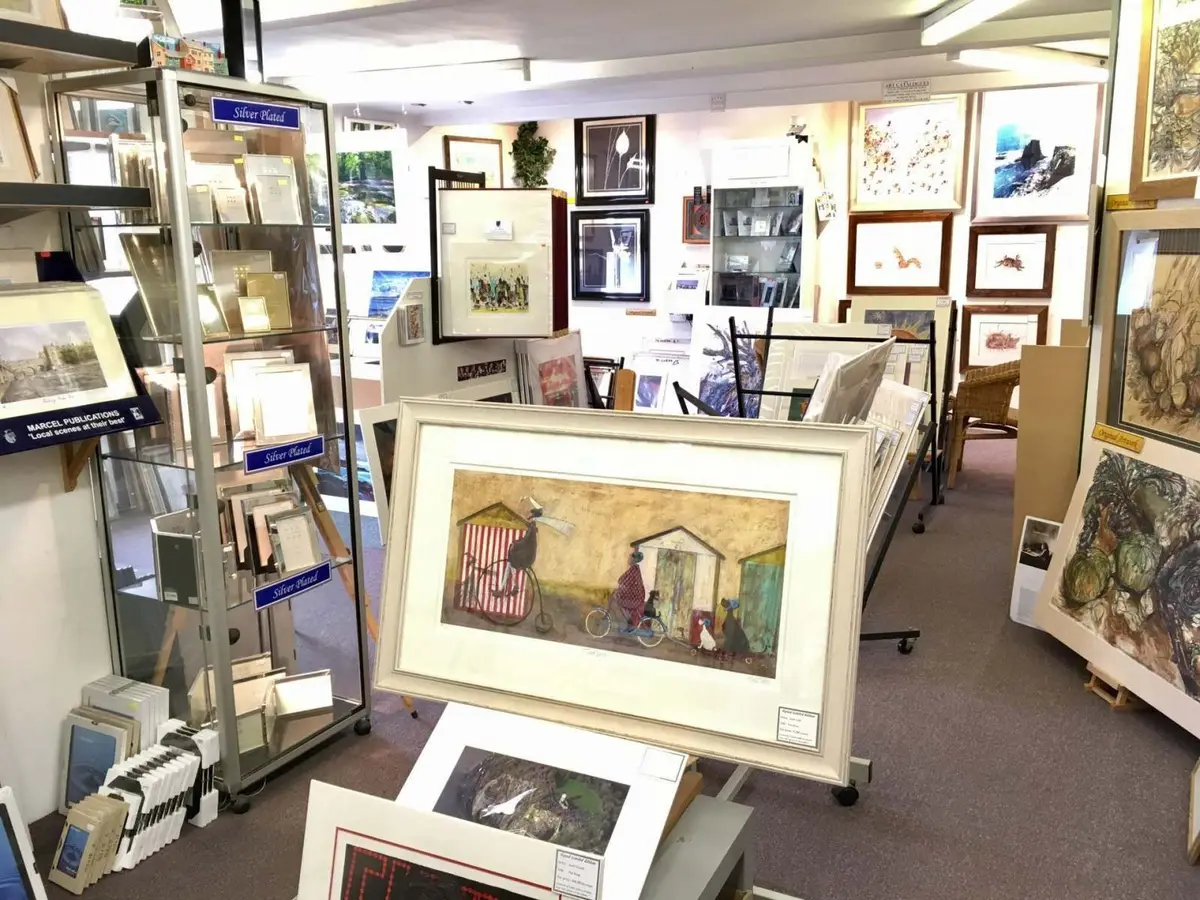 Inside Tripps of Keynsham with framed pictures on display